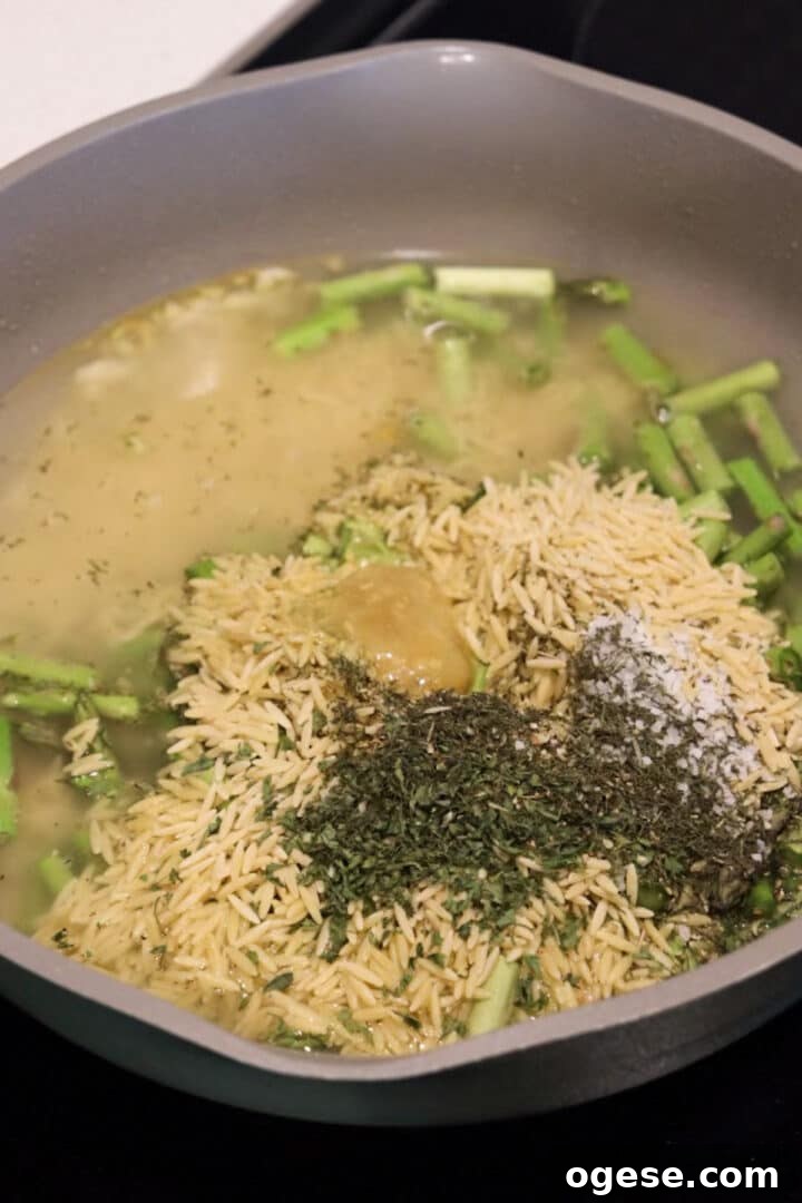 One-Pan Lemon Salmon and Orzo Recipe 9 All ingredients or lemon salmon orzo skillet in a pan, unstirred