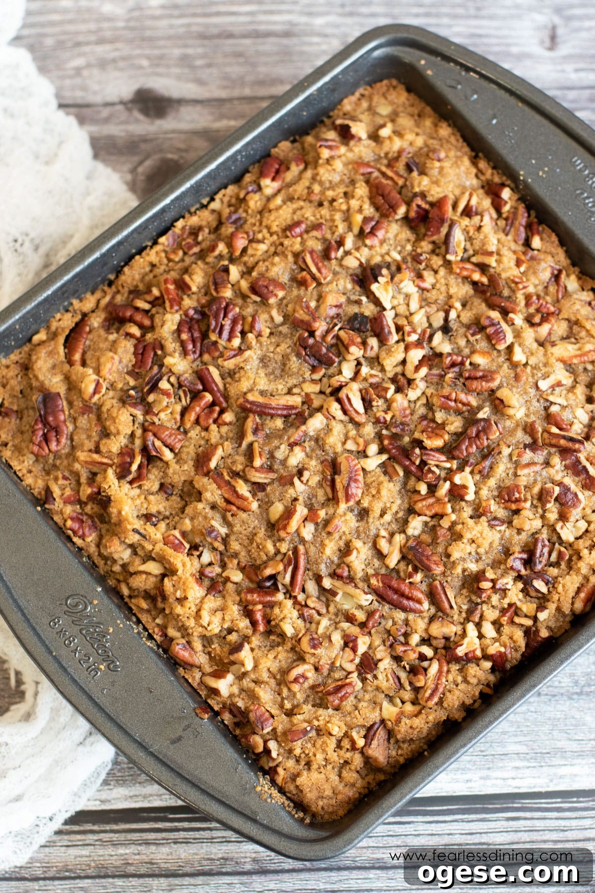 An 8x8 pan with a baked pumpkin coffee cake in it.