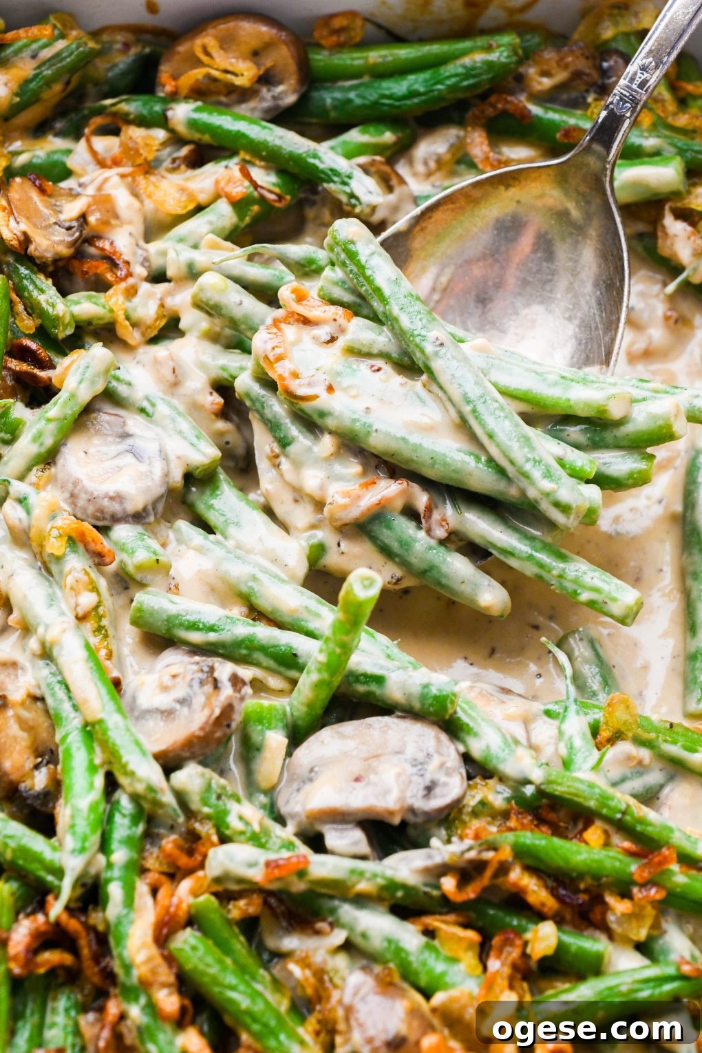 Dairy-Free Cashew Cream Green Bean Casserole (Gluten-Free) 16 Close up of a scoop of the creamy gluten free green bean casserole.