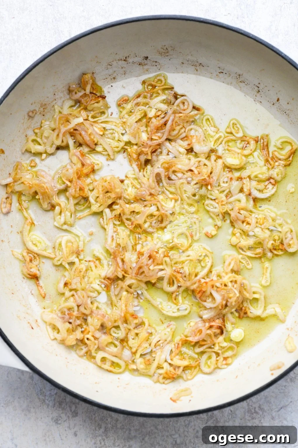 Dairy-Free Cashew Cream Green Bean Casserole (Gluten-Free) 5 Crispy fried shallots in a shallow ceramic skillet.