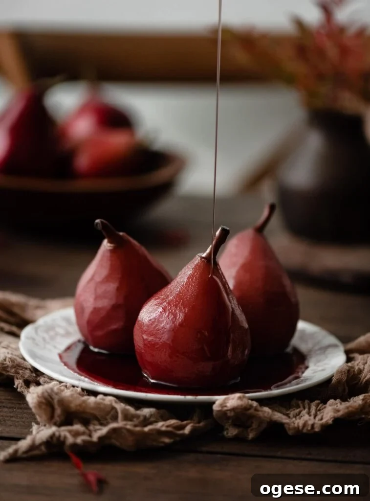 Red wine pears on plate with a drizzle of honey.
