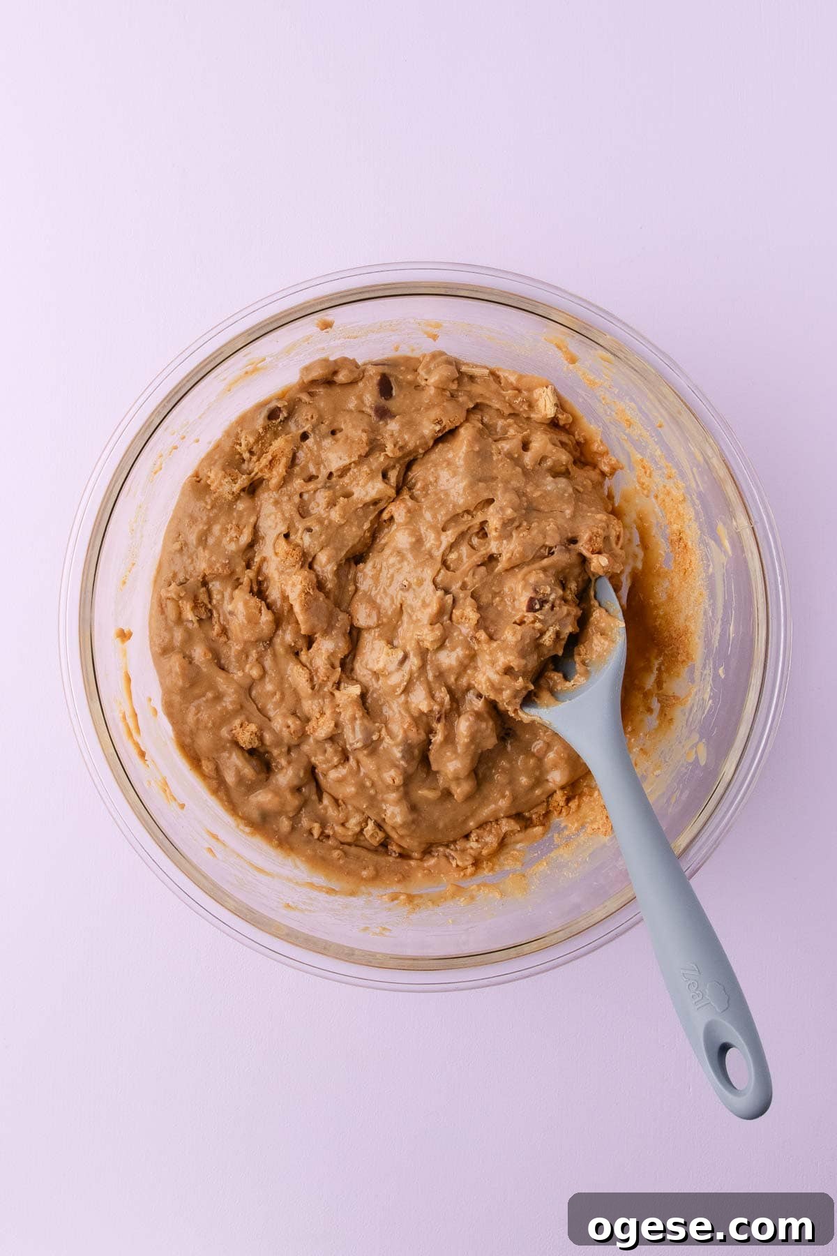 The chopped biscuits and twirls being stirred into the fudge mixture. 