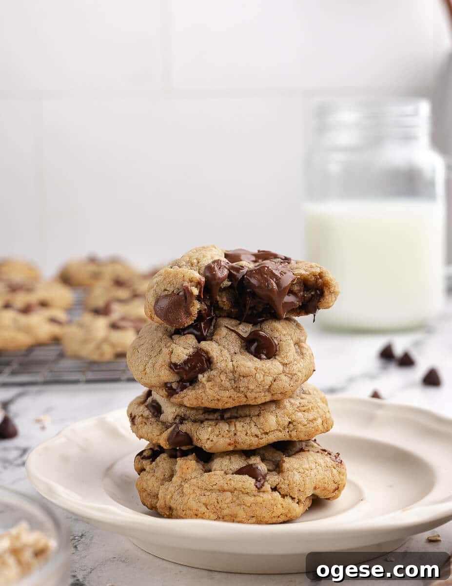 Gluten-Free Chocolate Chip Cookie Recipe You’ll Love 2 a stack of chocolate chip cookies with chocolate oozing out of the top cookie.