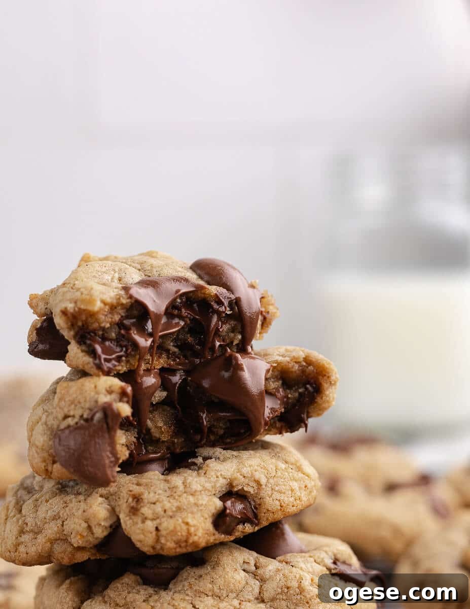 Gluten-Free Chocolate Chip Cookie Recipe You’ll Love 5 a stack of gluten free cookies with melted chocolate coming out of them.