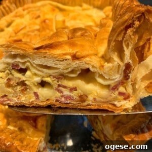 Ale’s Top Easter Recipes 2026: Festive Ideas for Your Holiday 8 A close-up of a slice of pie being served, showcasing layers of flaky golden-brown pastry filled with creamy cheese and pieces of ham. The rest of the pie is in the background.