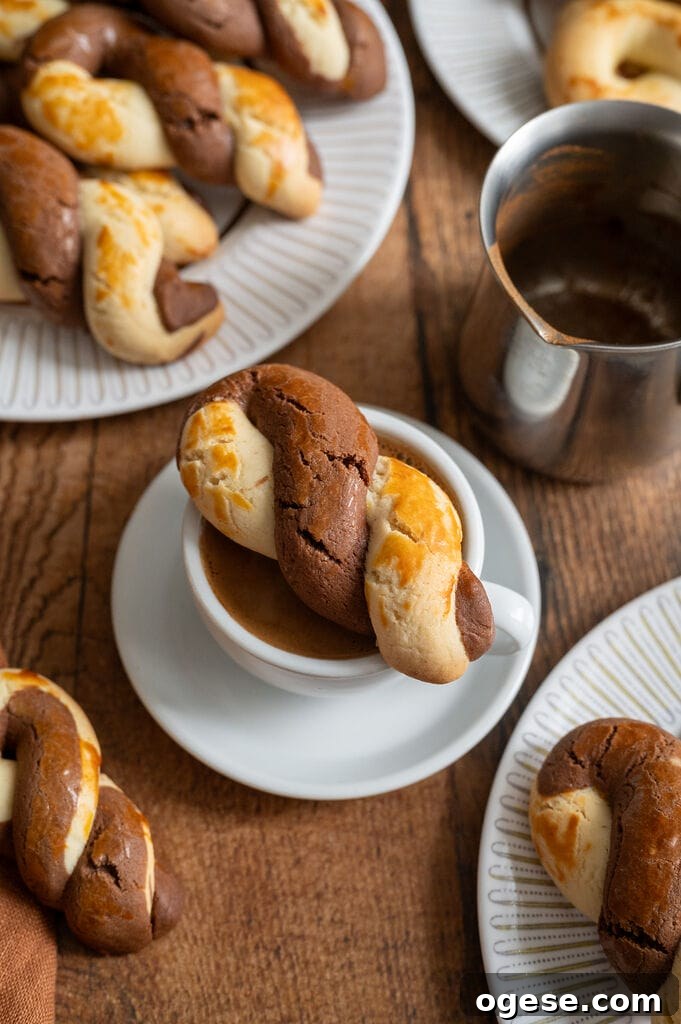 Greek Butter Koulourakia Cookies with Chocolate Swirl 24 Greek butter koulourakia with a chocolate twist sitting on top of the cup of Greek coffee.