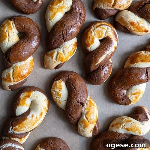 Greek Butter Koulourakia Cookies with Chocolate Swirl 28 Greek butter koulourakia with a chocolate twist on a baking tray.