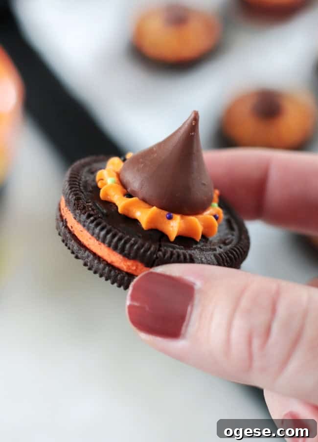 hand holding a witch hat cookie