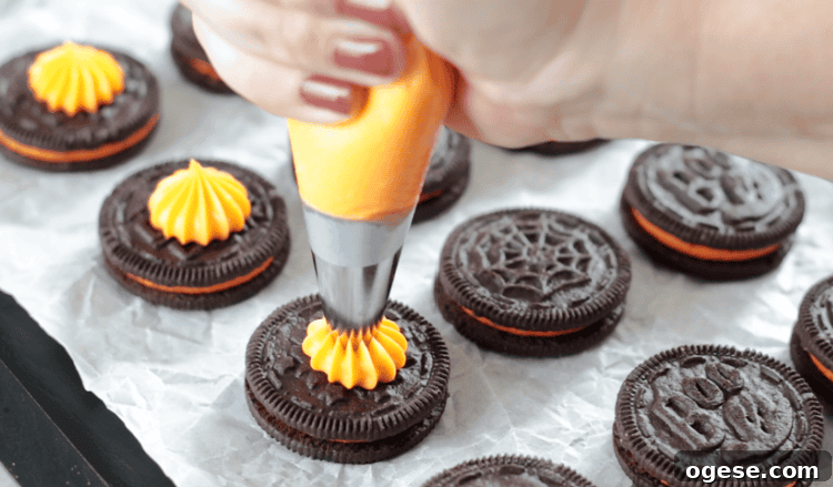 frosting piped onto oreo cookies