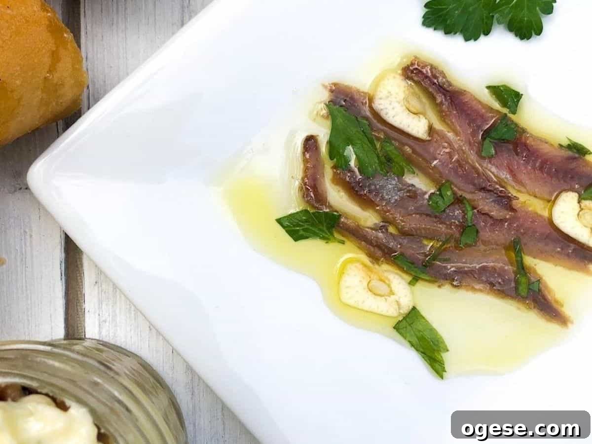 Anchovies on a plate with garlic.