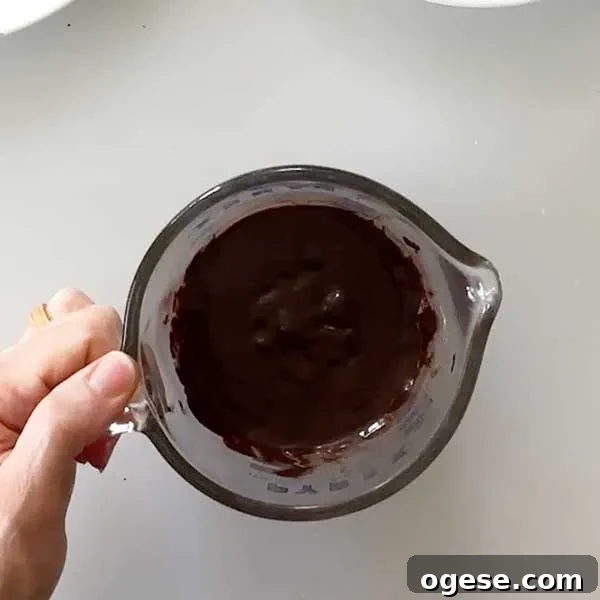 Chocolate Peanut Butter Cottage Cheese Ice Cream Bars — High-Protein Treat 11 Melted chocolate chips in a microwave-safe measuring bowl.