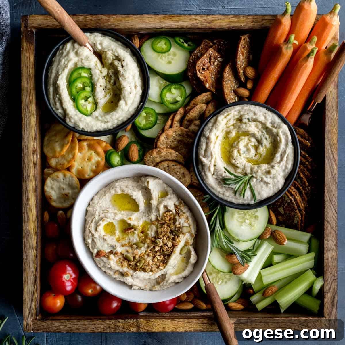 Creamy White Bean Dip: Three Flavorful Variations 2 Overhead of 3 variations of white bean dip served with crackers and veggies.