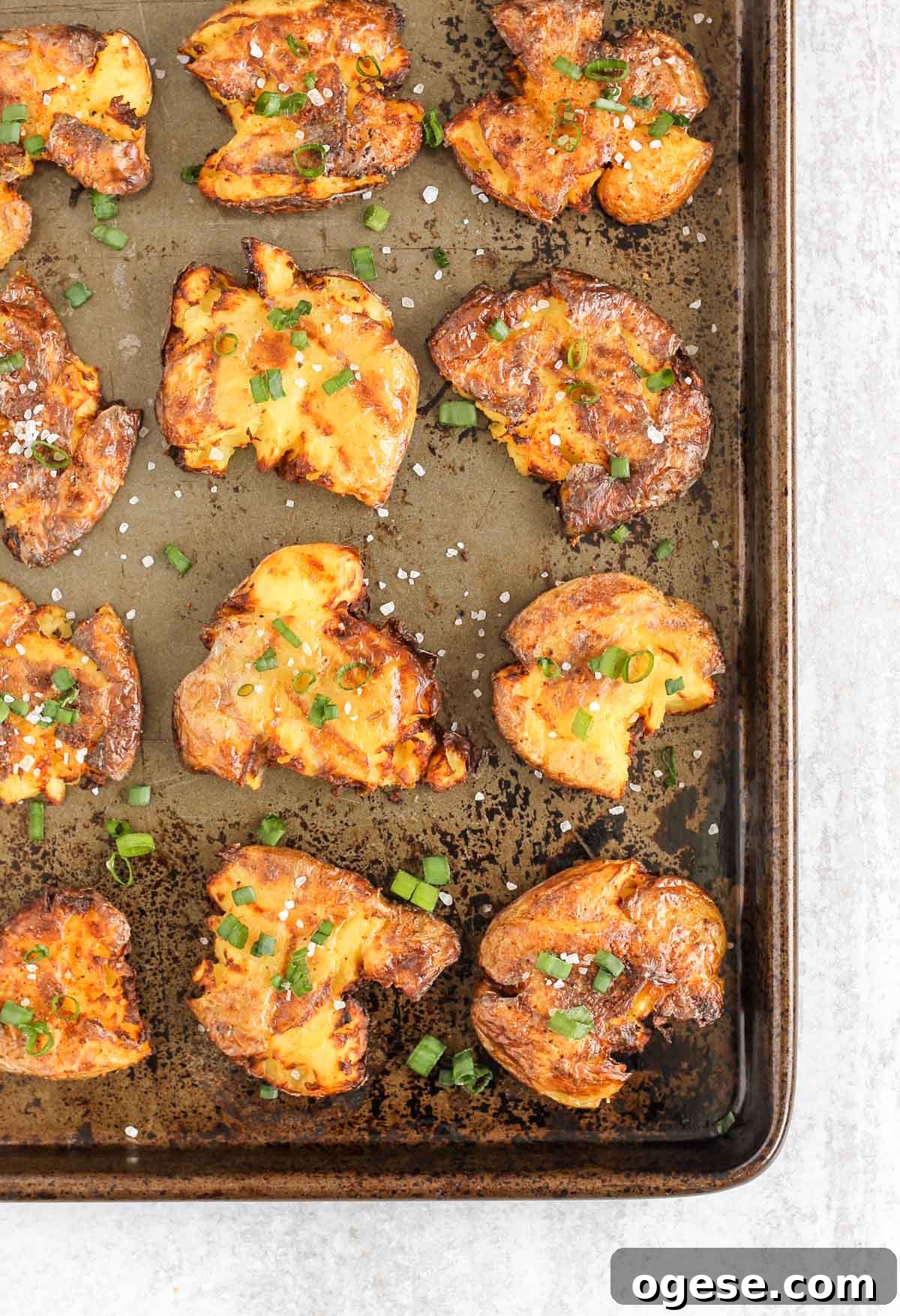 Fried smashed potatoes on a baking sheet.