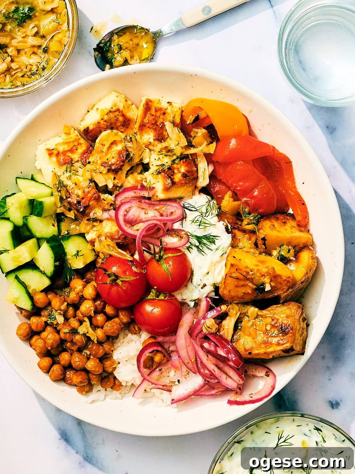 Greek Veggie Feta Bowls with tzatziki, crispy chickpeas, dill, and marinated onions.