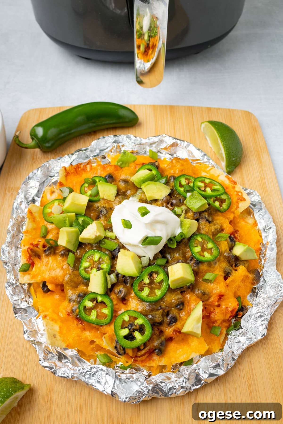 Crispy Air Fryer Nachos with Cheese & Quick Toppings 8 A close up image of air fryer nachos that's ready to be served.