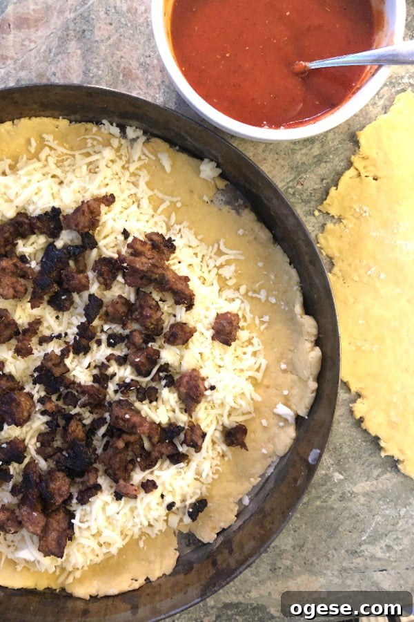 Double-Crust Stuffed Pizza: Ultimate Guide to Making It at Home 3 making a pizza with tomato sauce, Italian sausage and mozzarella cheese