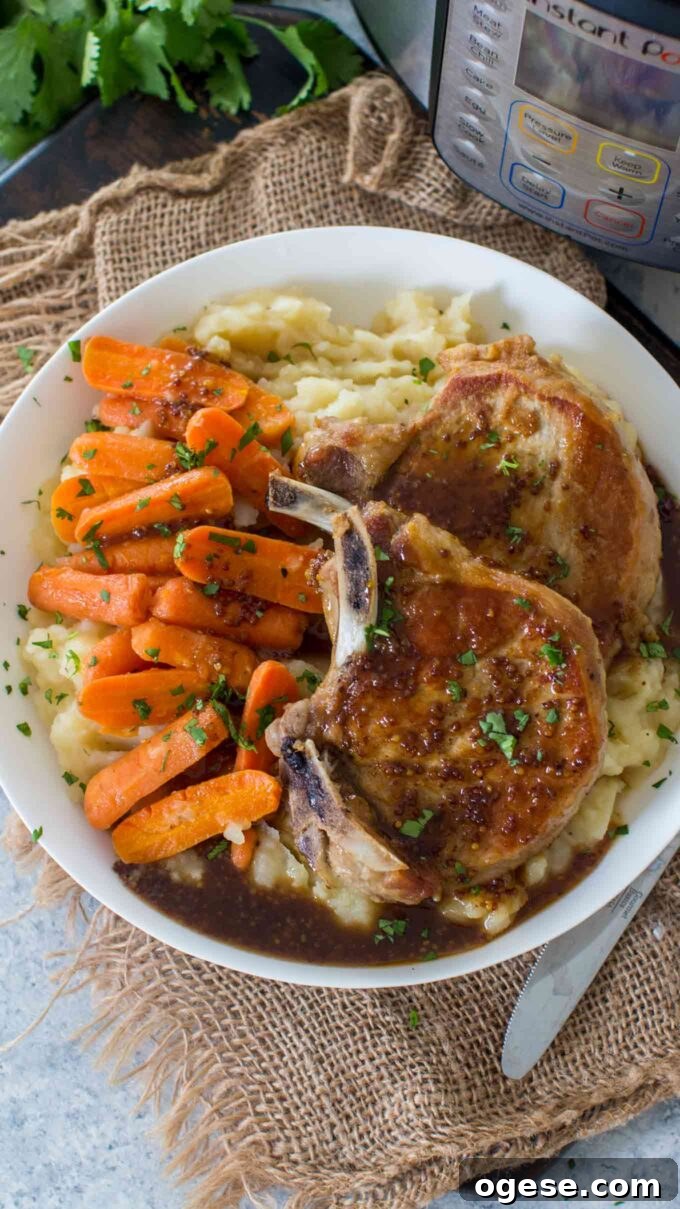 Overhead shot of Instant Pot pork chops with carrots and mashed potatoes. 