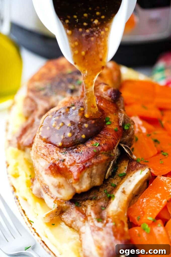 Pouring apple cider sauce over browned Instant Pot pork chops.