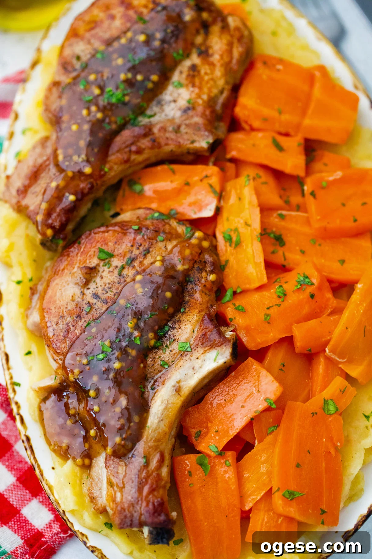 Homemade Instant Pot apple cider pork chops with carrot chunks and mashed potatoes.