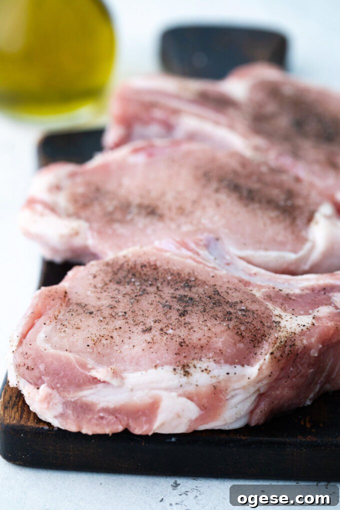 Seasoning bone-in pork chops.