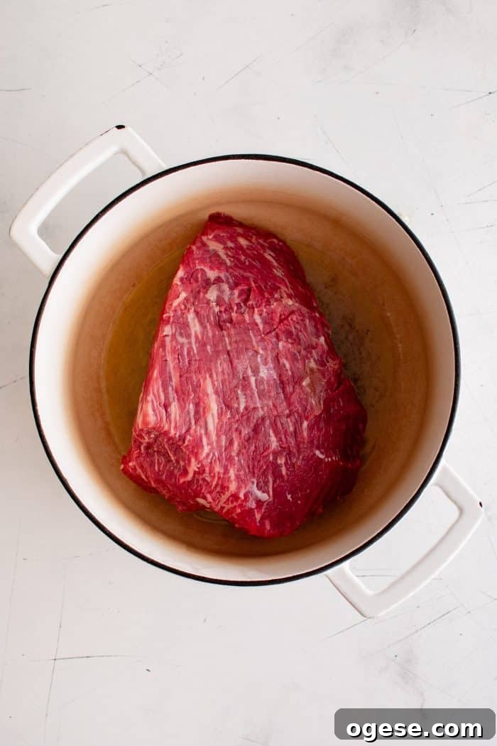 Classic Italian Beef Sandwich Recipe: Tender Slow-Cooked Roast Beef on Italian Bread 5 Large raw and uncooked rump roast in a large Dutch oven.