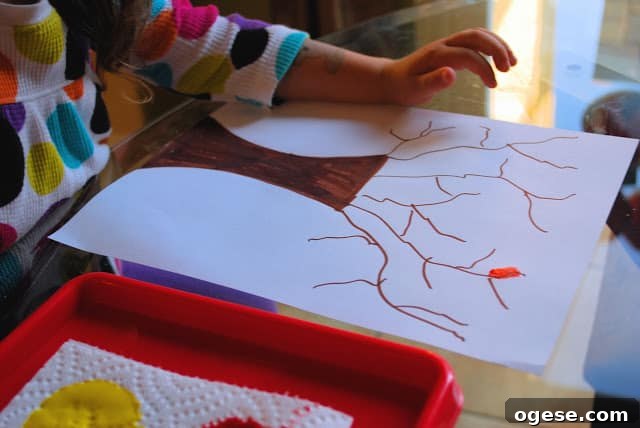 Fingerprint Fall Tree Crafts for Kids: Simple Autumn Art Project 6 child decorating paper tree