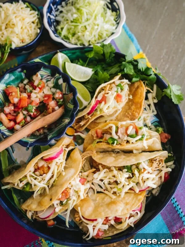 overhead shot of a serving platter of homemade crispy chicken tacos