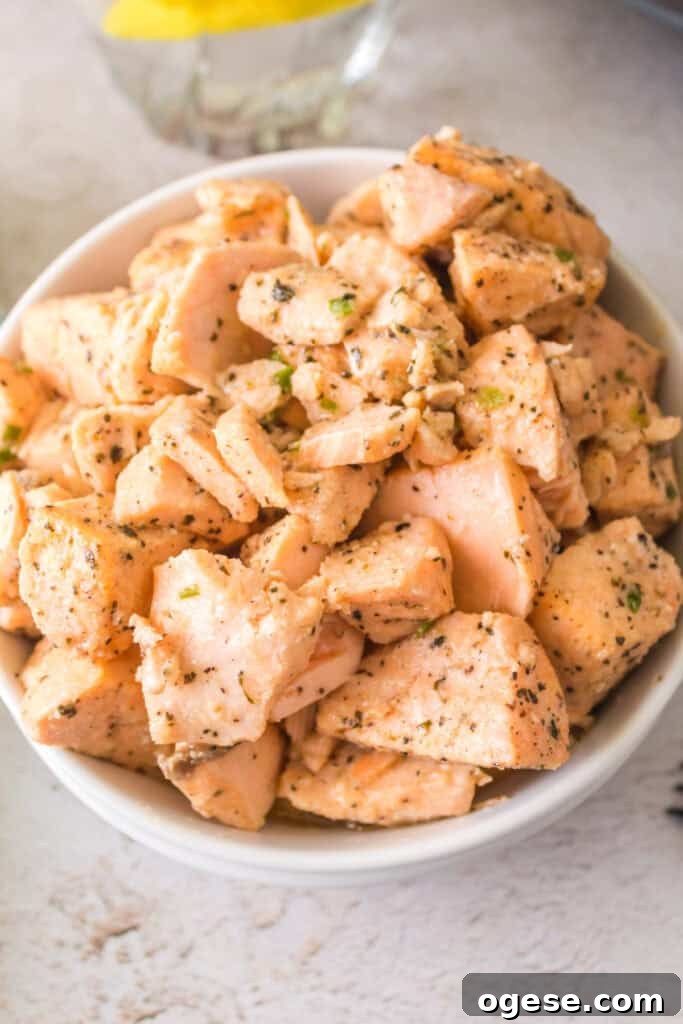 Crispy Air Fryer Salmon Bites with Lemon-Dill Dip 22 Overhead shot of a bowl of air fryer salmon bites garnished with herbs, ready to serve.