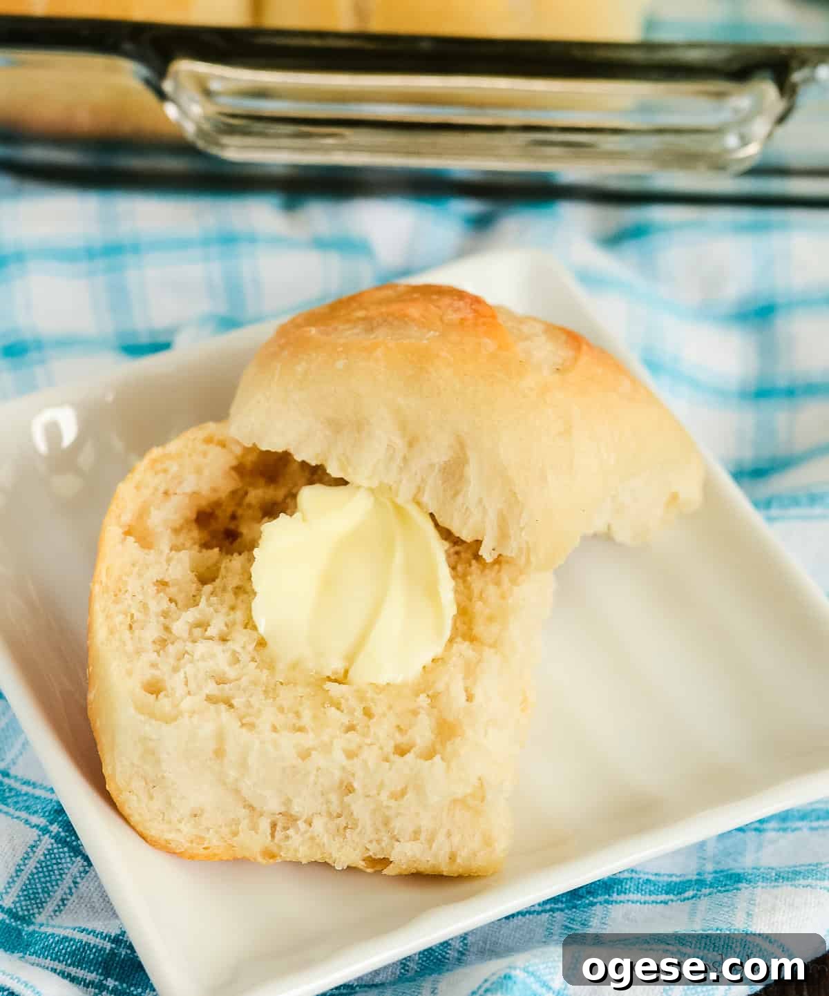 sourdough dinner roll with a pat of butter