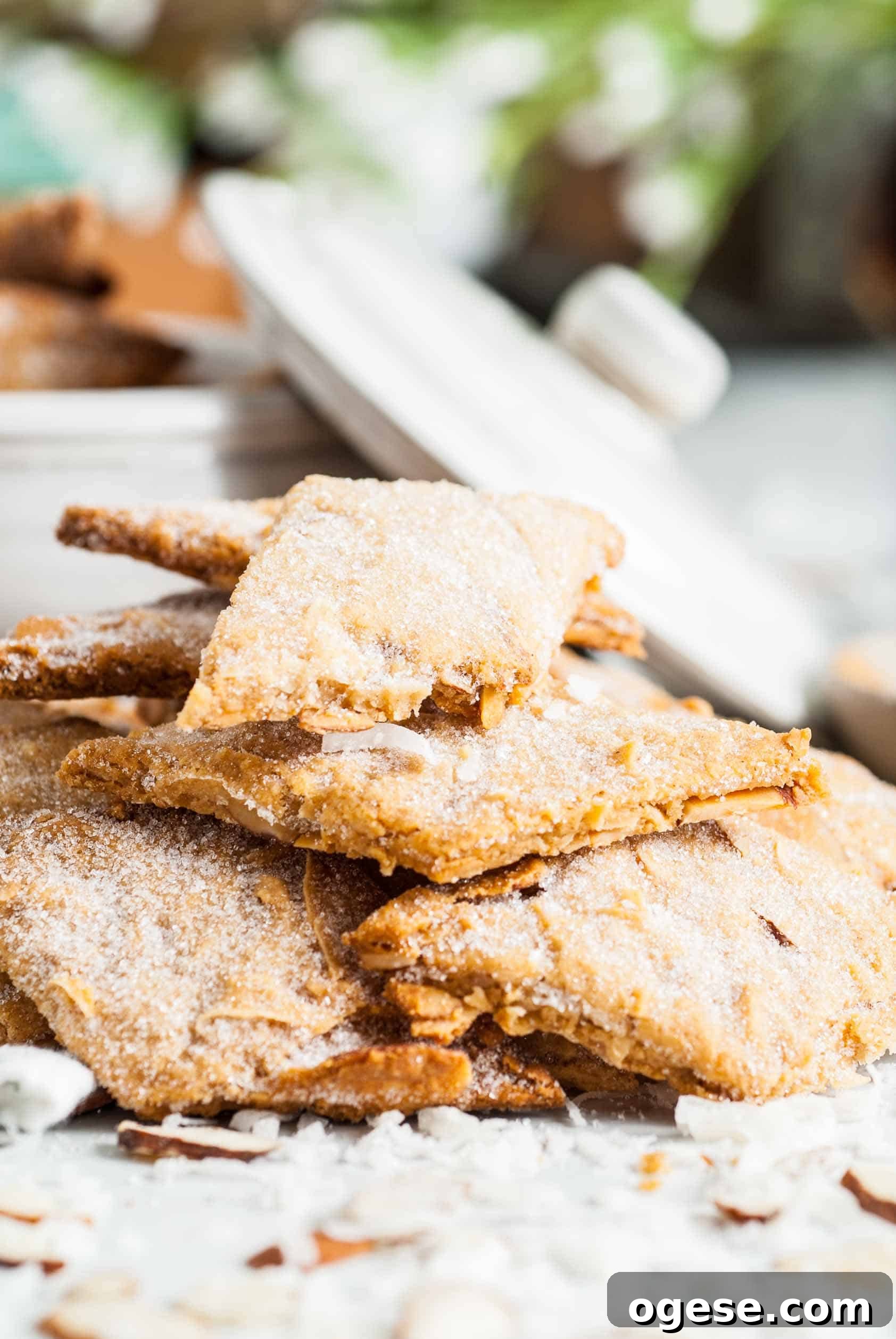 Coconut Almond Sourdough Crackers Recipe for Crispy Homemade Snacks 2 Close up view of crackers piled in front of a bowl.