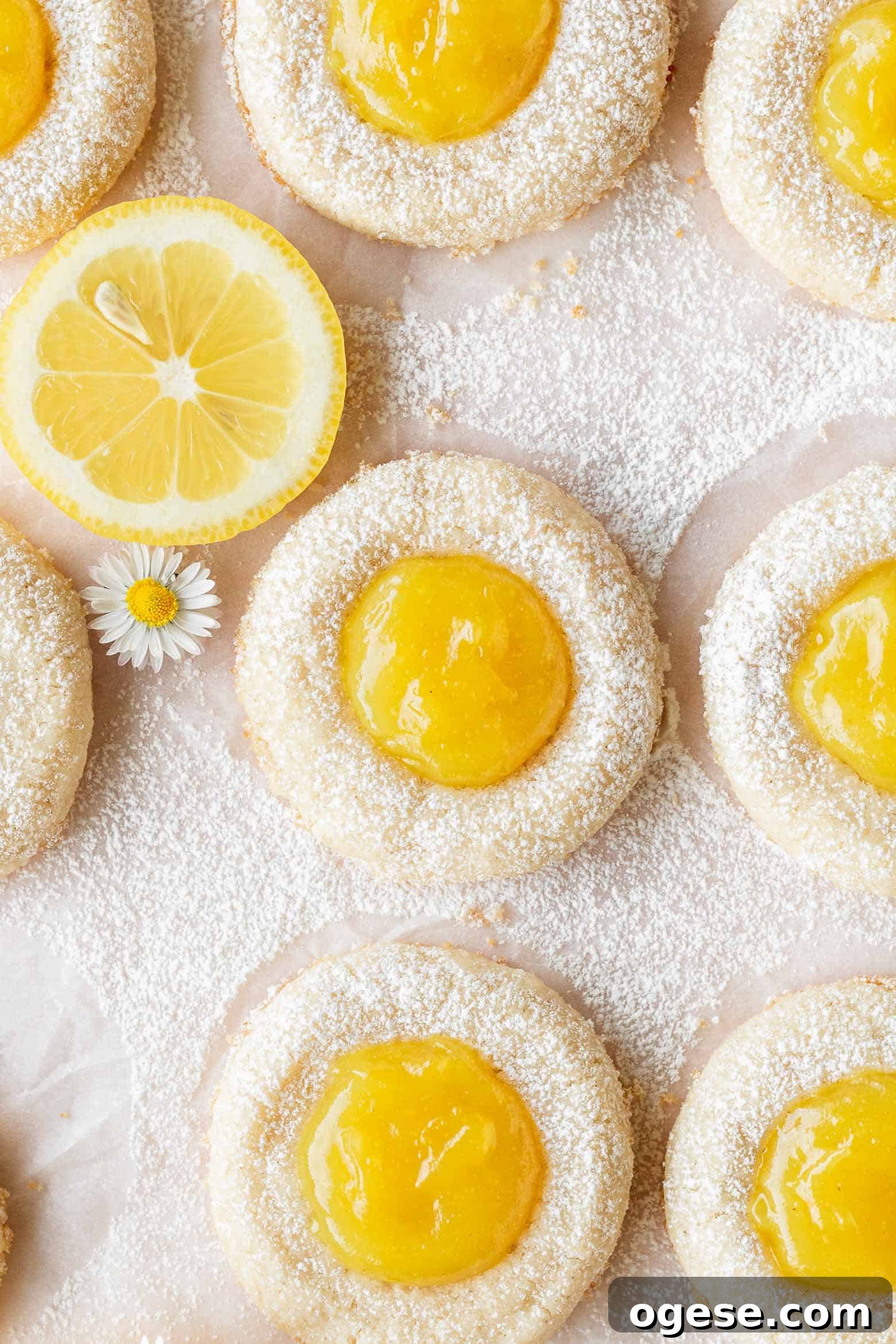Overhead shot of lemon curd cookies dusted with powdered sugar.