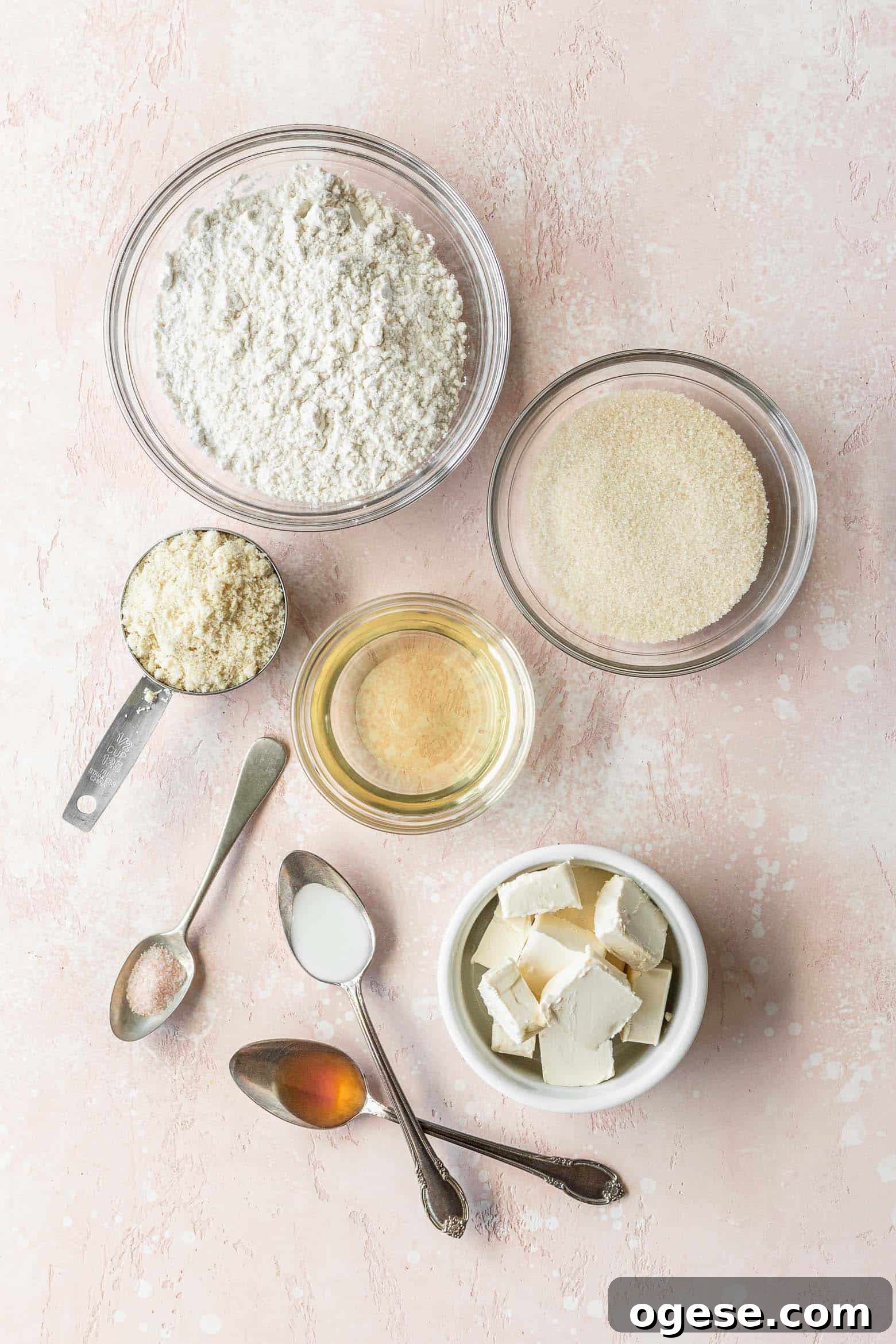 Vegan sugar cookie ingredients measured out into bowls on a pink surface.