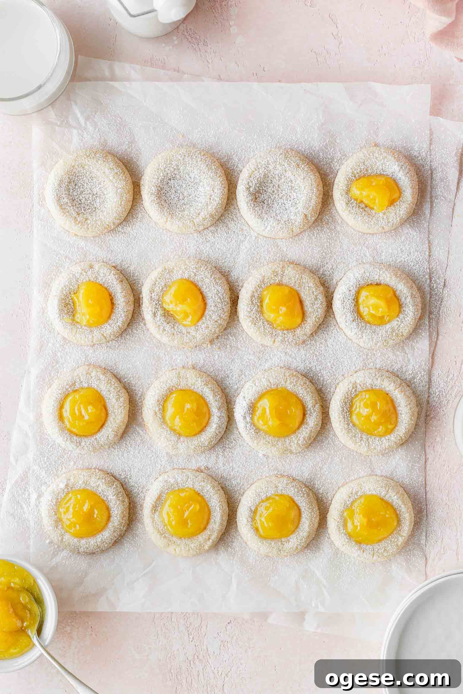 Lemon thumbprint cookies being filled with lemon curd.