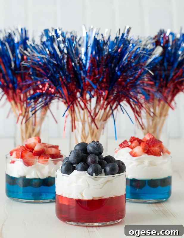 Patriotic 4th of July Fruit and Jello Cups Recipe 5 blue and red jello in glass cups topped with whipped cream and chopped strawberries and blueberries
