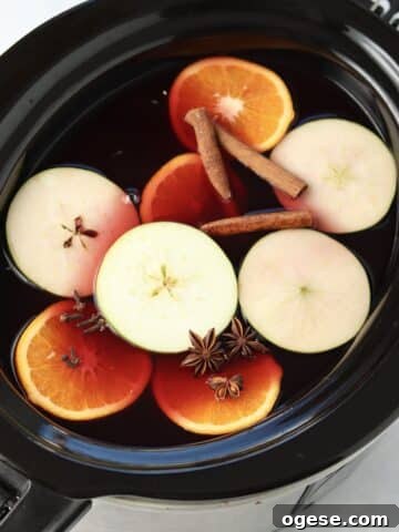 mulled wine with apple cider in slow cooker.