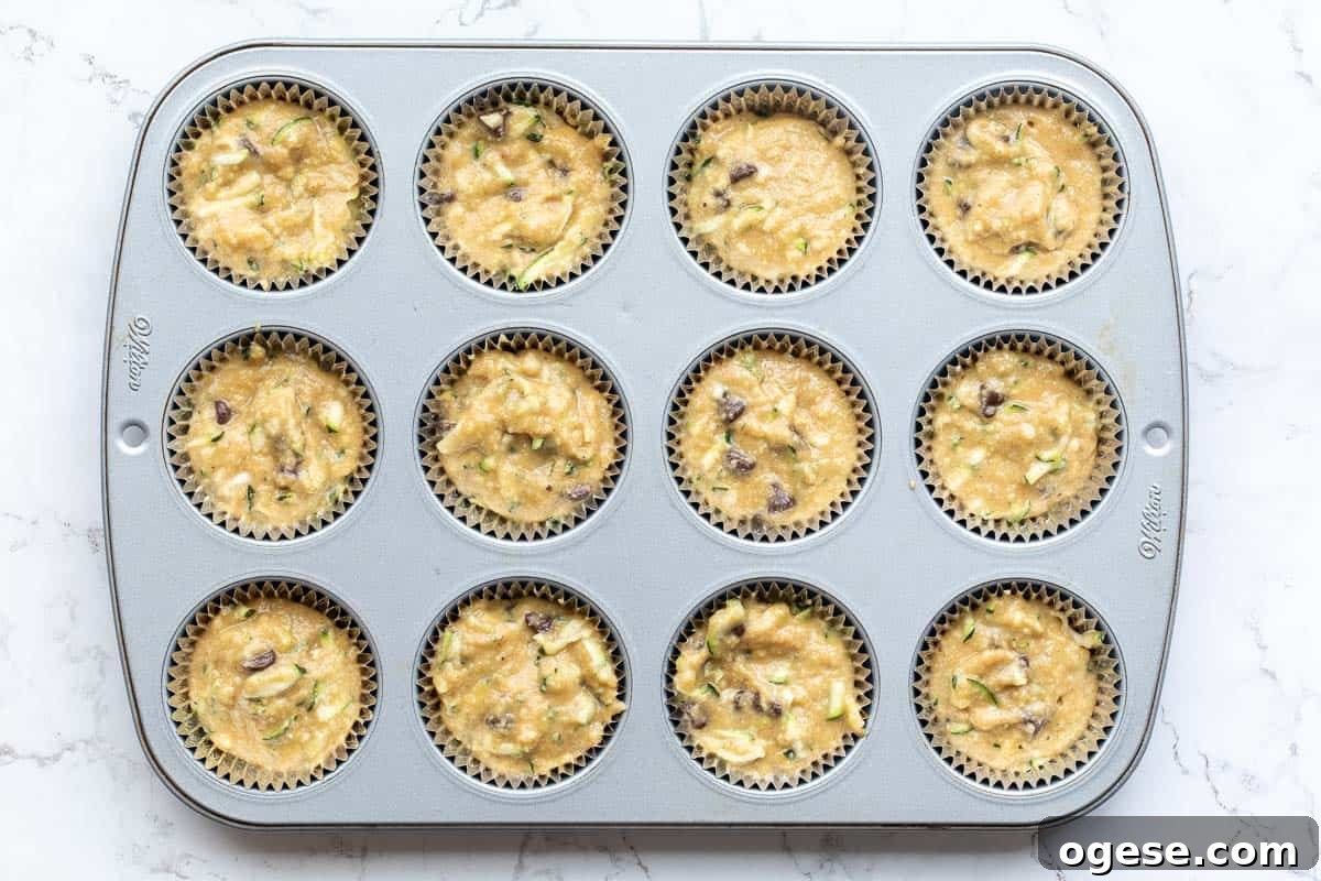 almond flour zucchini muffin batter in cupcake tin ready to bake.