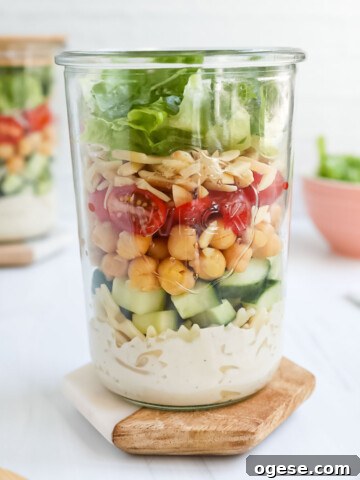 A layered salad in a mason jar.