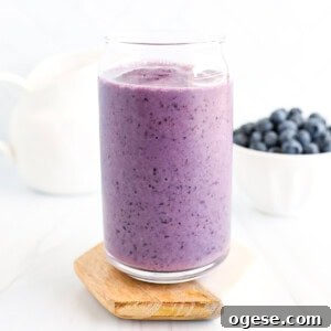 Blueberry Peanut Butter Smoothie Recipe for Creamy Energy Boost 10 A blueberry smoothie in a clear cup.