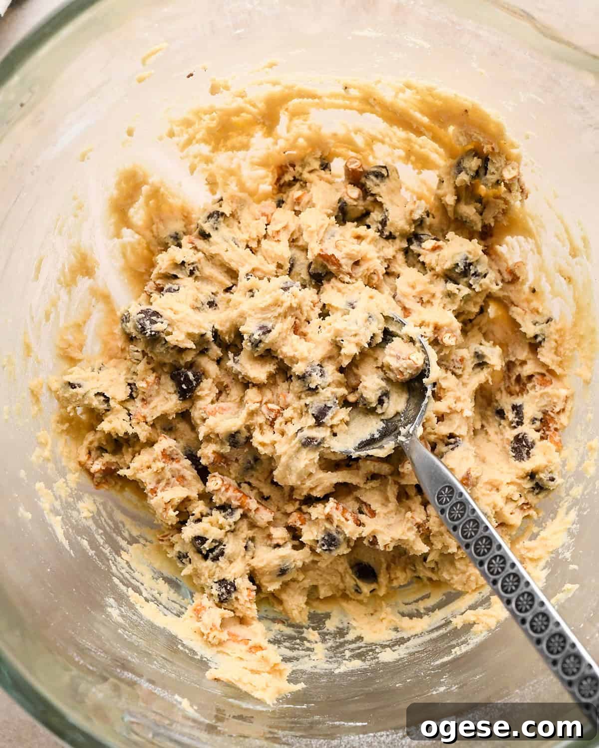 Salted Pretzel Chocolate Chip Cookies: Sweet Meets Crunch 14 chocolate chip pretzel cookies dough mixed with a spoon in it