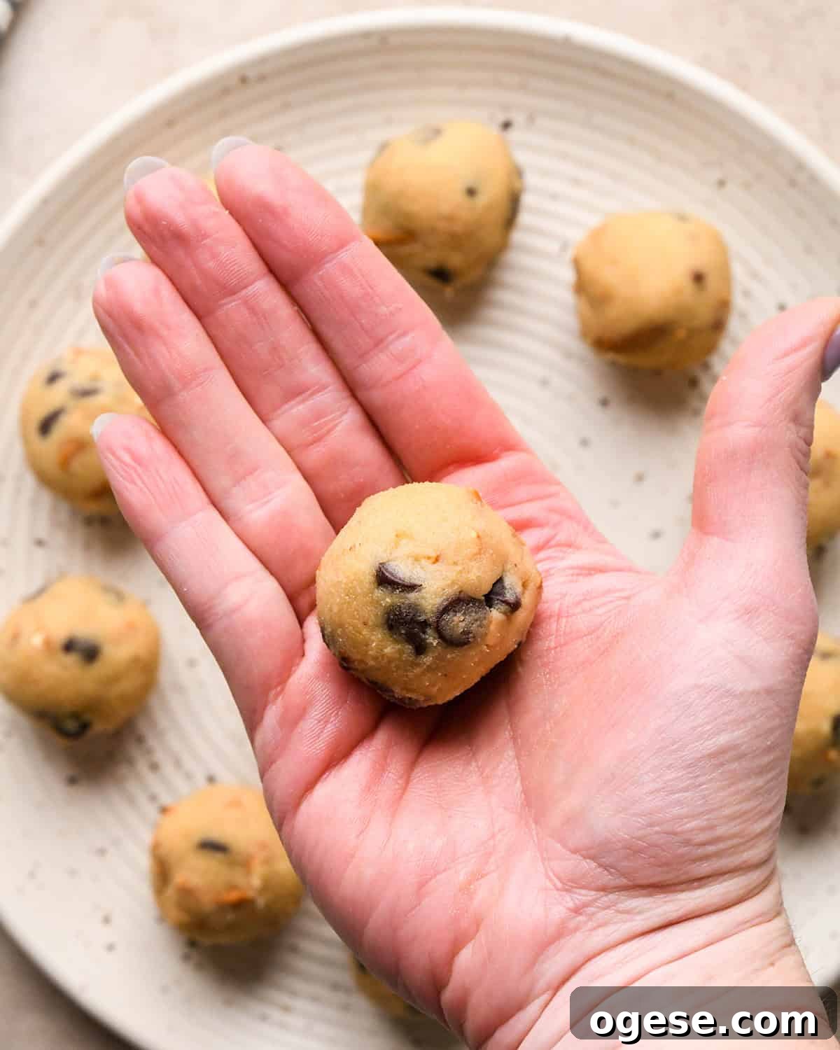 Salted Pretzel Chocolate Chip Cookies: Sweet Meets Crunch 17 a hand rolling a ball of cookie dough