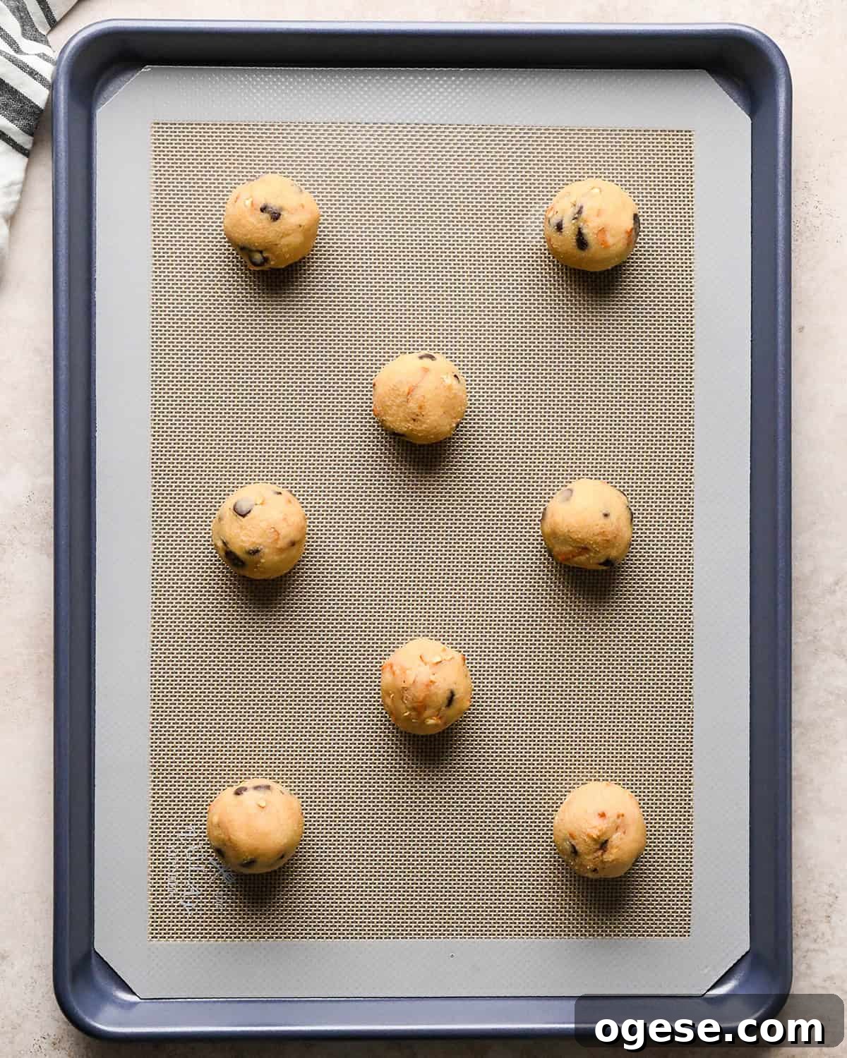 Salted Pretzel Chocolate Chip Cookies: Sweet Meets Crunch 18 8 balls of chocolate chip pretzel cookies dough on a baking sheet before baking