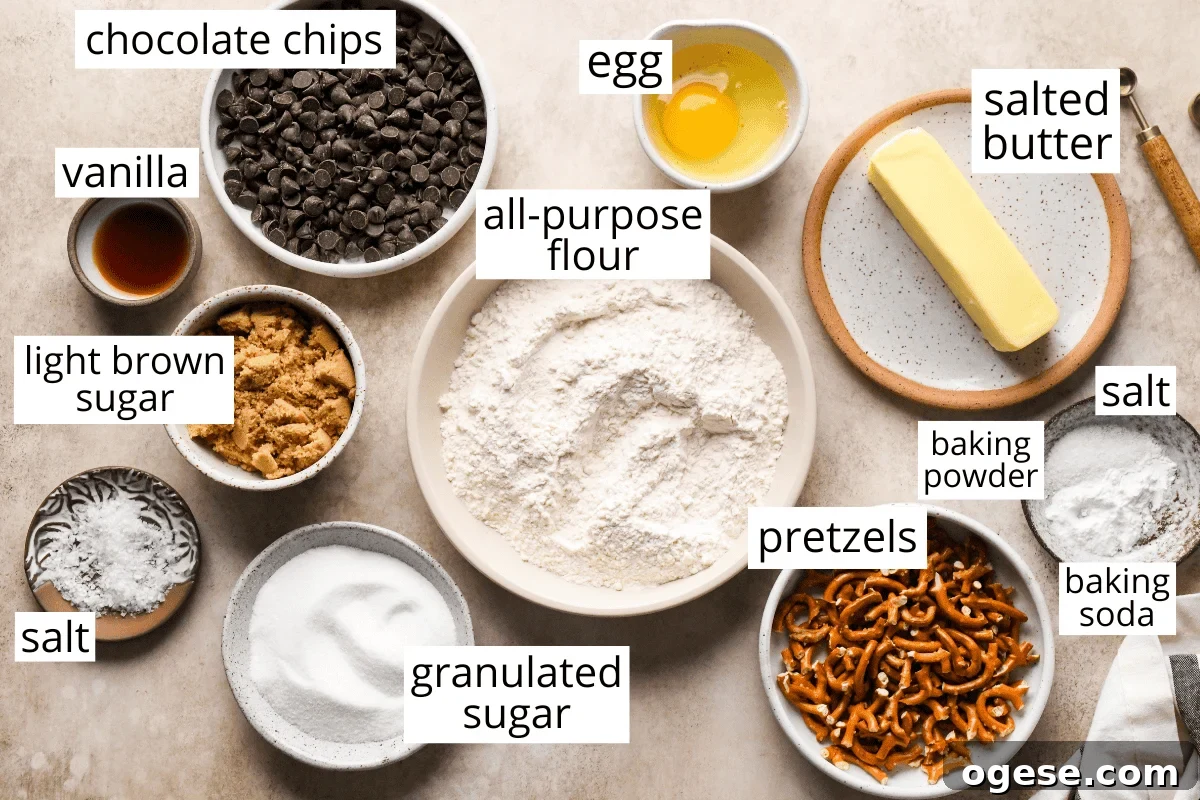 Salted Pretzel Chocolate Chip Cookies: Sweet Meets Crunch 4 overhead photo of the labeled ingredients in this Chocolate Chip Pretzel Cookies recipe like butter, flour, egg, chocolate chips, sugar, and pretzels.