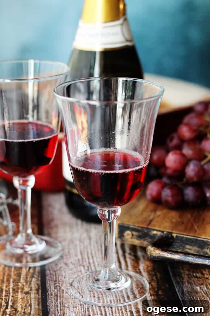 Italian Dessert Wine Brachetto in glasses with bottle and grapes in the back