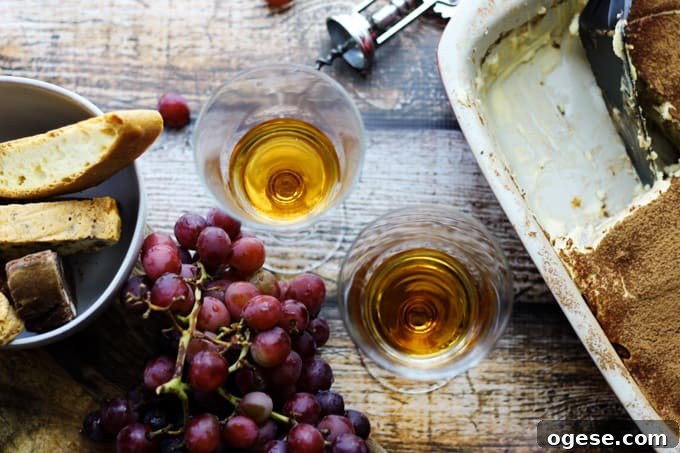 Italian Dessert Wine Passito in glasses with grapes and desserts on a side