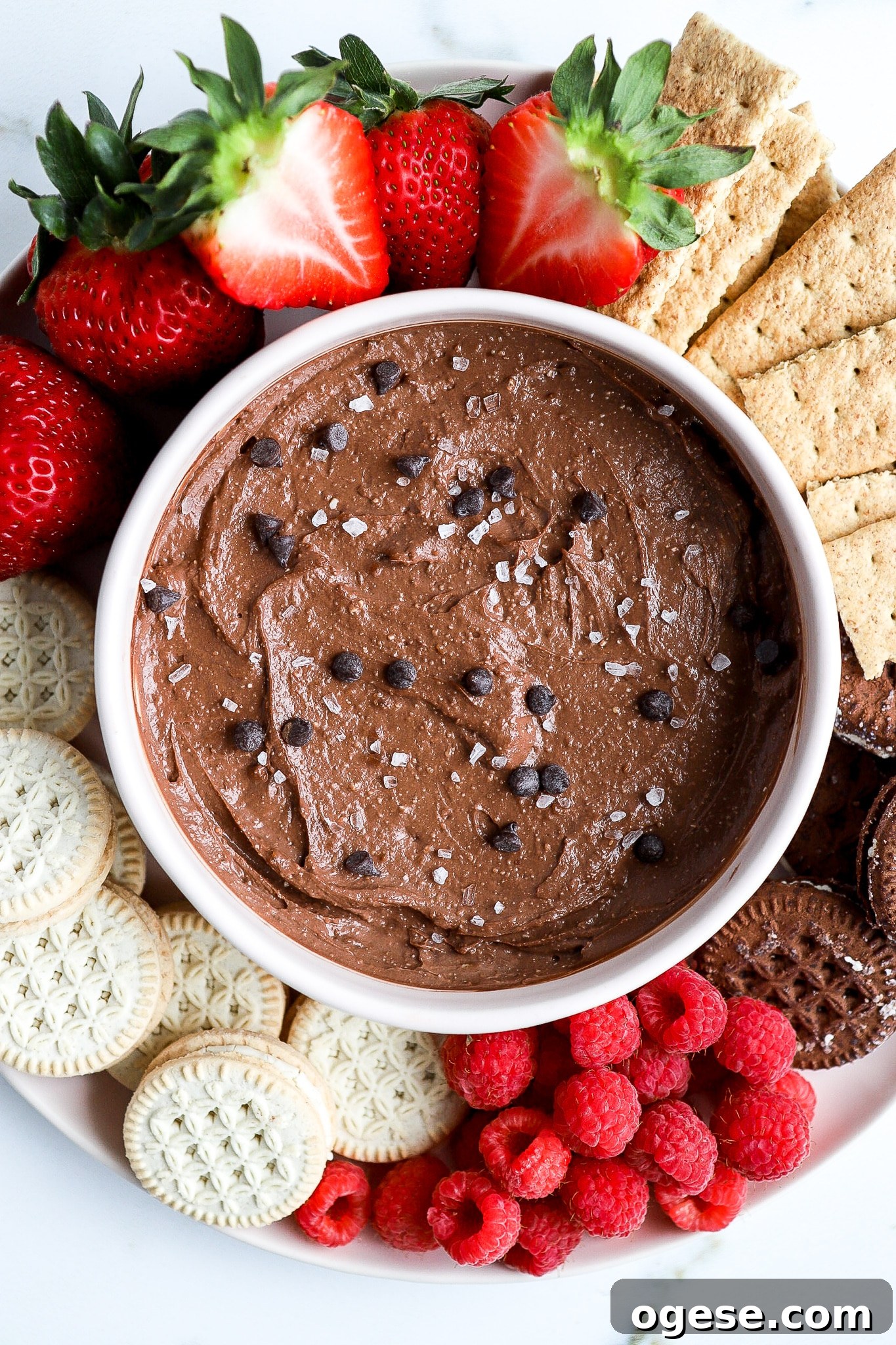Chocolate Cottage Cheese Fruit Dip: Creamy Chocolate Dessert Recipe 3 top down view of healthy fruit dip in a pink bowl with fresh fruit and graham crackers around it
