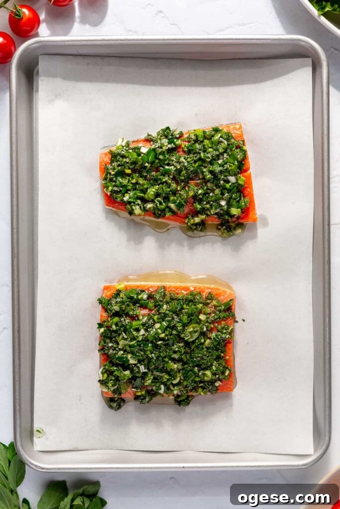 Wild salmon baking in the oven for a healthy salmon Niçoise salad recipe.