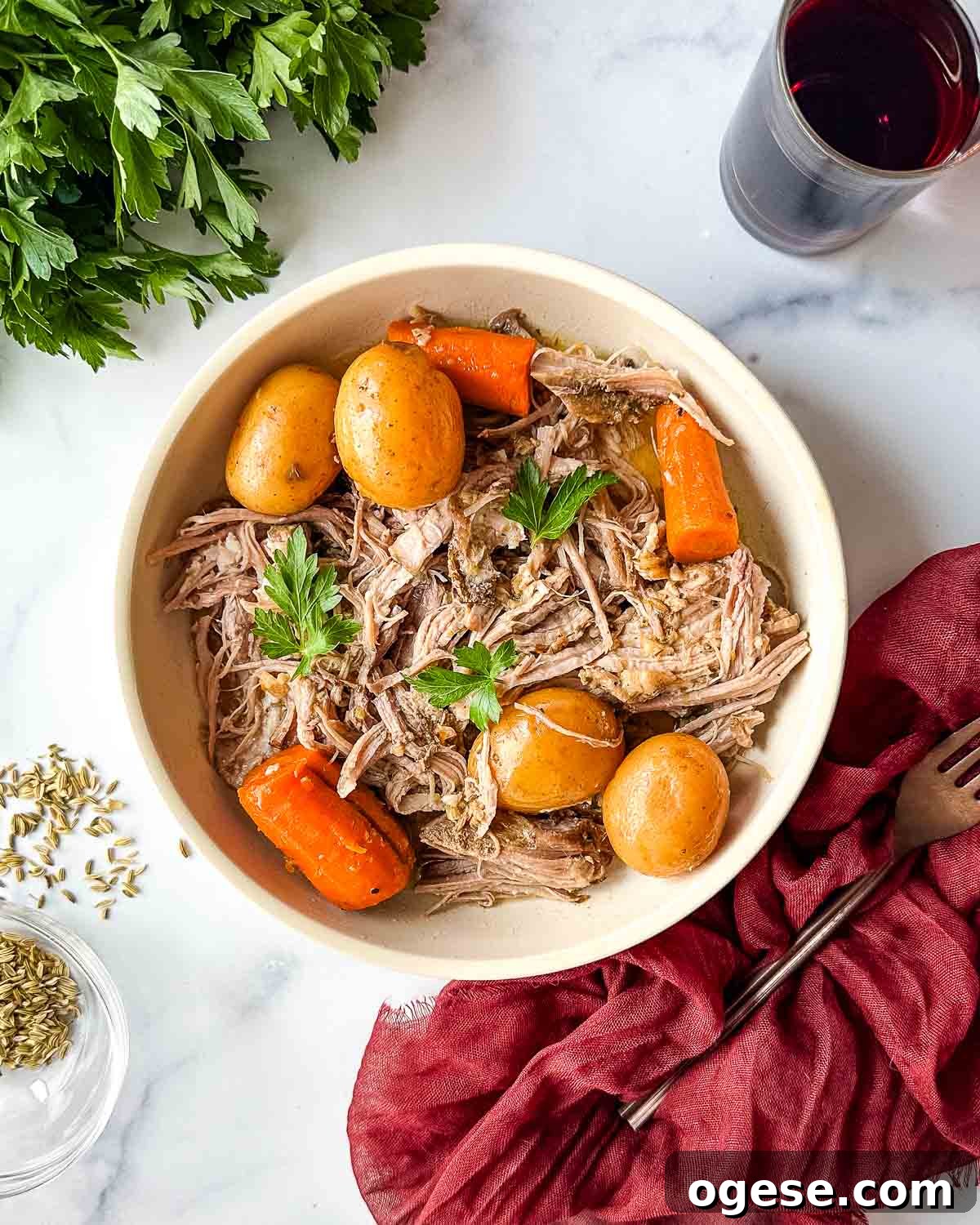 Slow Cooker Italian Pork Roast with Garlic and Herbs 2 A bowl of roast pork with carrots and potatoes.