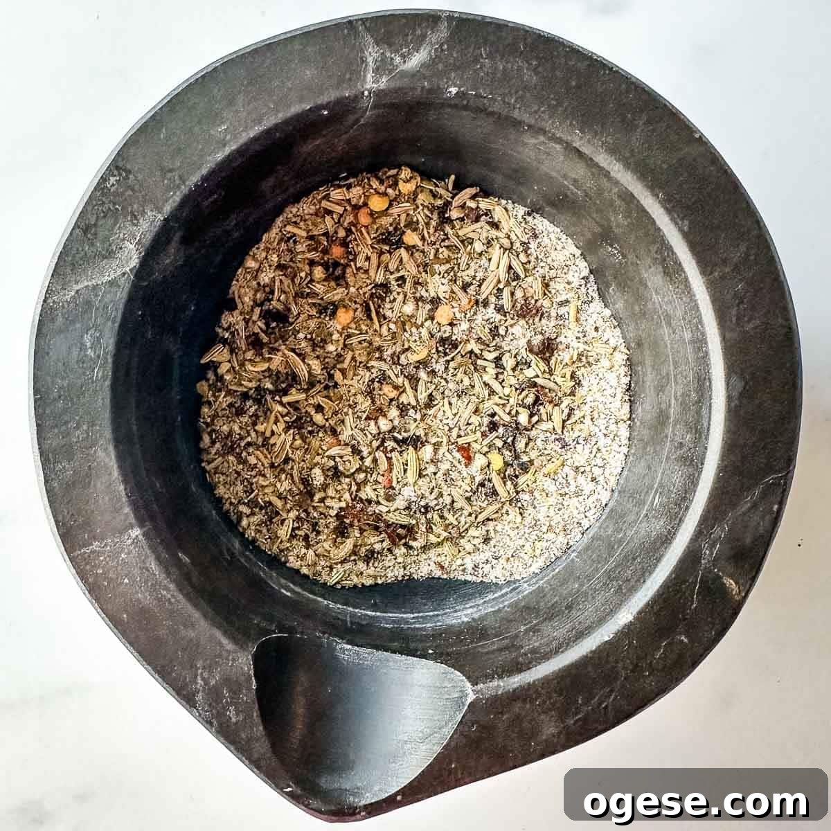 Slow Cooker Italian Pork Roast with Garlic and Herbs 7 A mortar filled with ground herbs and spices.