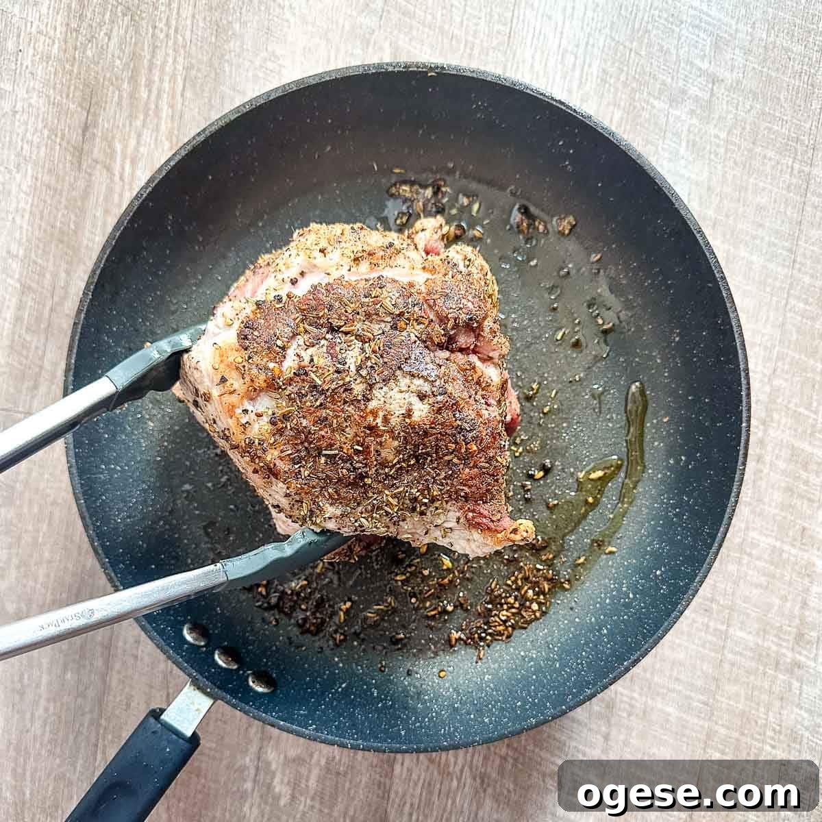 Slow Cooker Italian Pork Roast with Garlic and Herbs 10 A pork roast is browned in a frying pan.