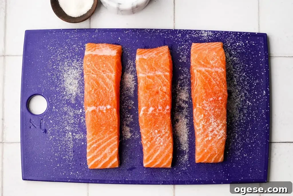 Seasoned Salmon three seasoned salmon filets on a cutting board